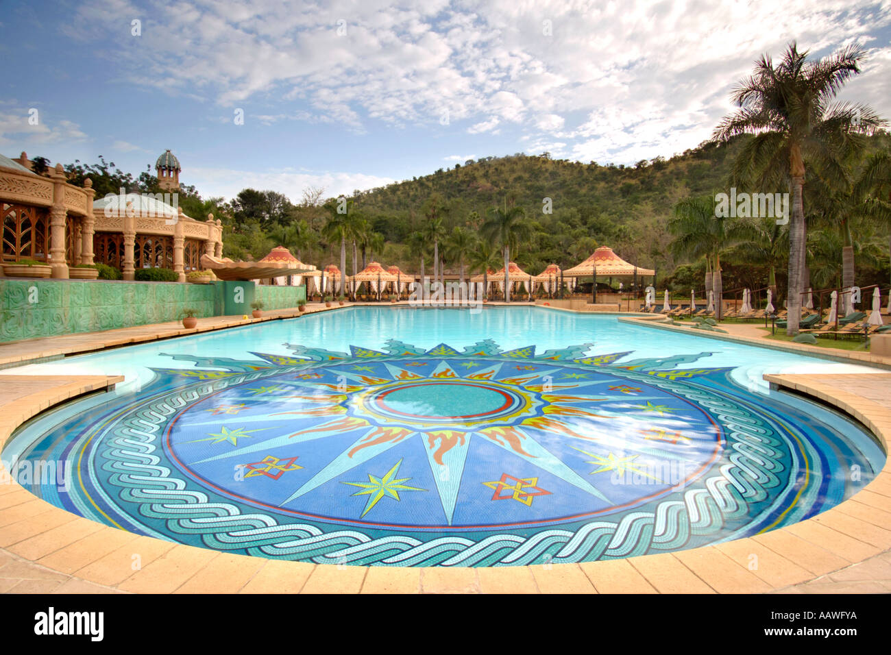 A dawn view of the swimming pool outside the Palace of the Lost City hotel in the Sun City resort in South Africa. Stock Photo