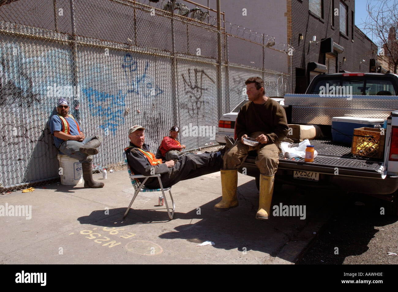 Workmen having lunch break in lower Manhatten. Stock Photo