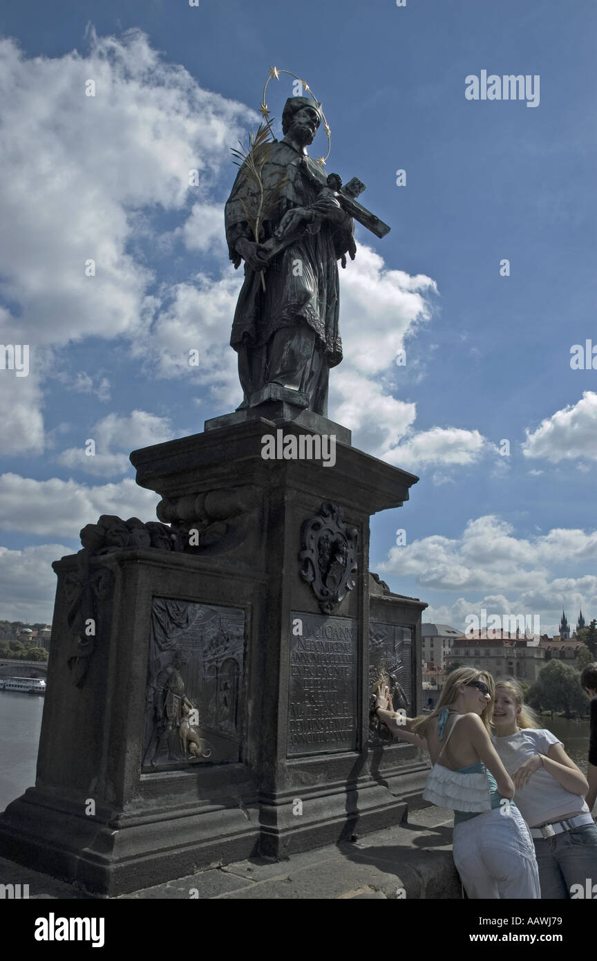 Rubbing the statue of St Nepomuk for goodluck on the Charles Bridge