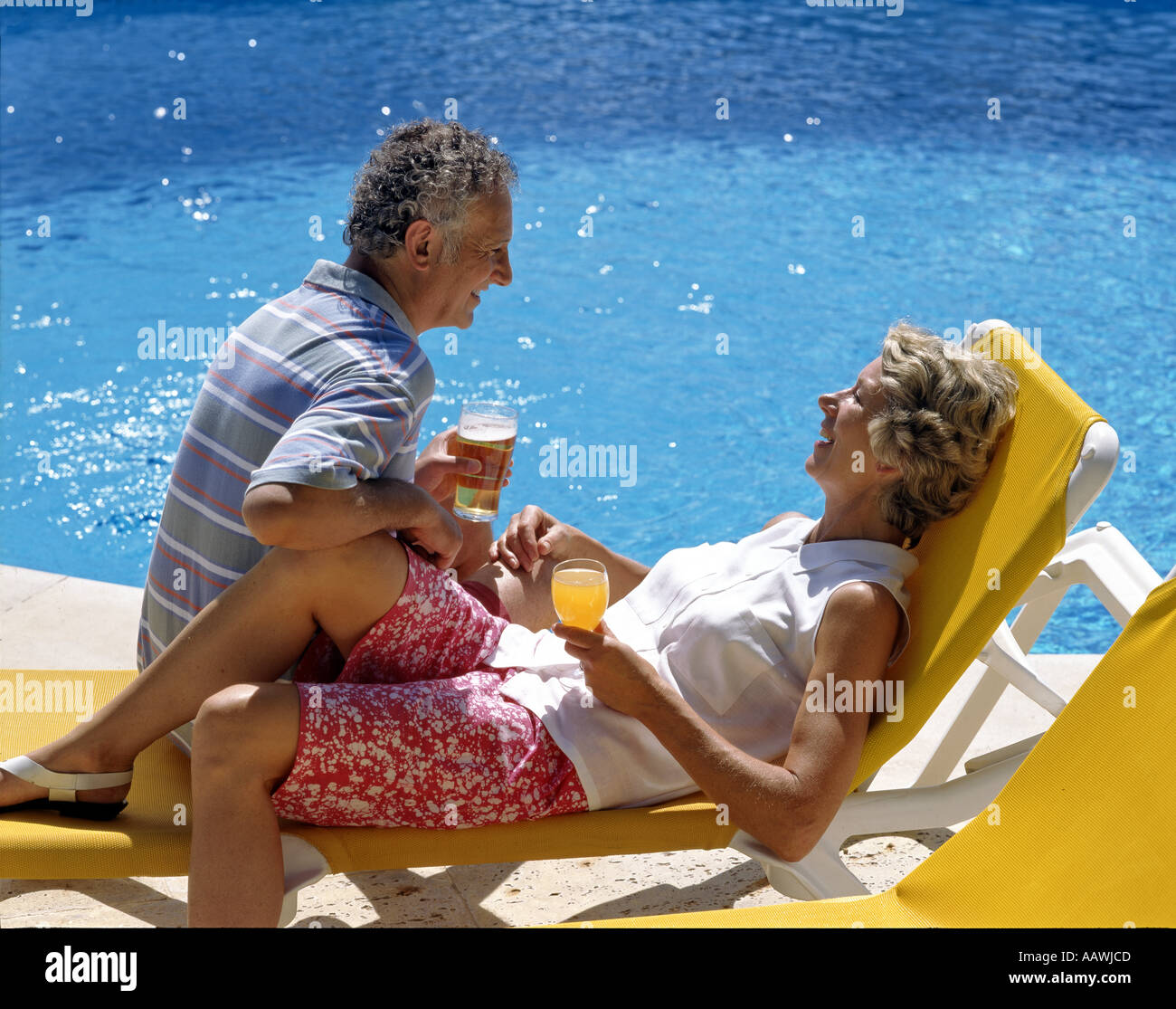 Senior couple relaxing by the Pool Stock Photo - Alamy