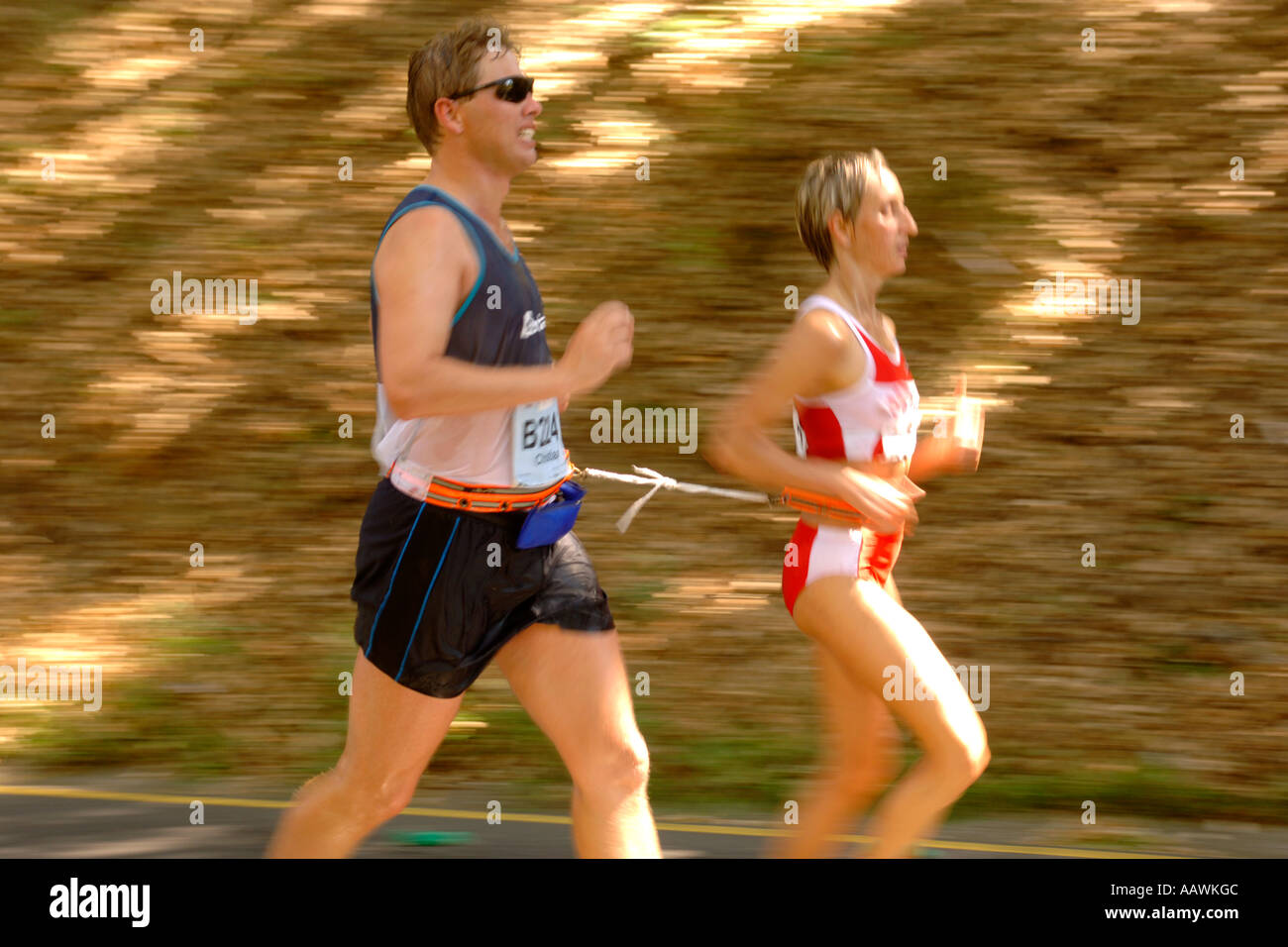 A couple run tethered in the 2006 Old Mutual Two Oceans marathon in Cape Town, South Africa. Stock Photo
