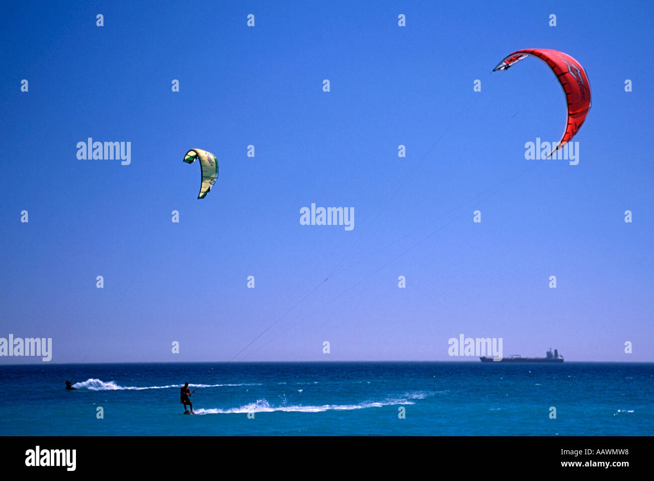 Kite surfers off Blouberg in Table Bay South Africa with an oil tanker in the background. Stock Photo