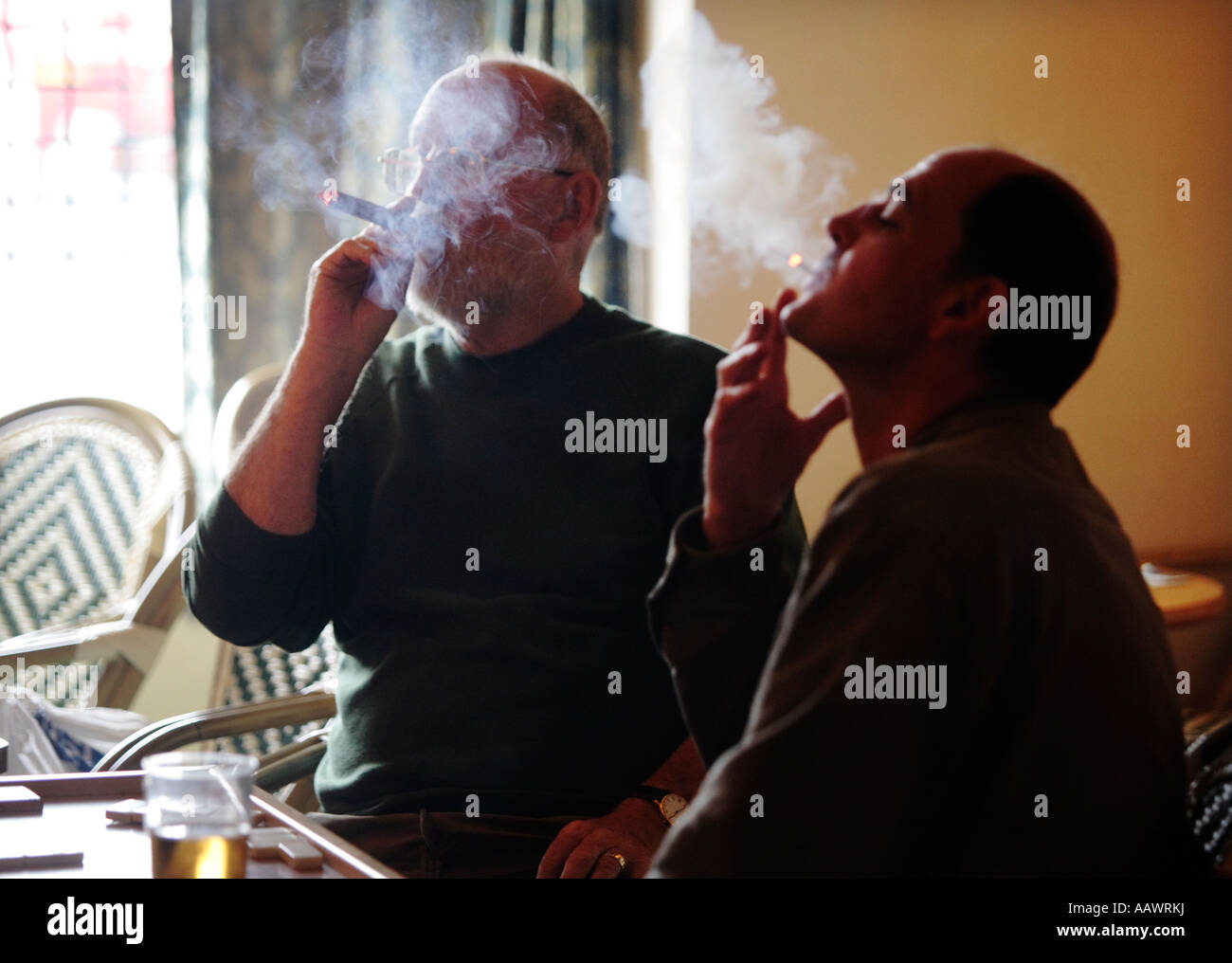 Two smokers puffing away in a pub in Worcestershire UK the day before the  smoking ban in public places came in to force Stock Photo