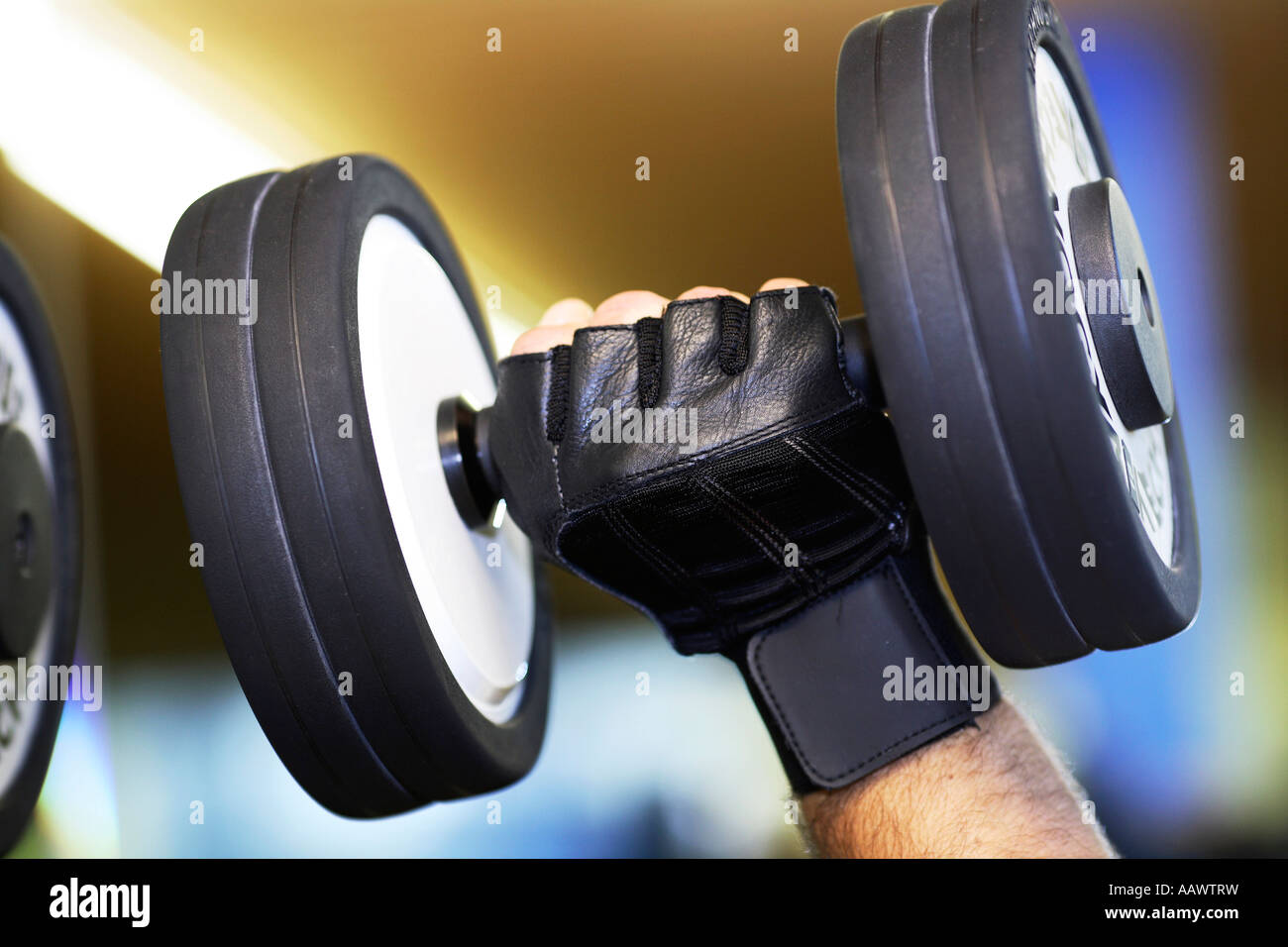 Hand lifts a dumbell Stock Photo