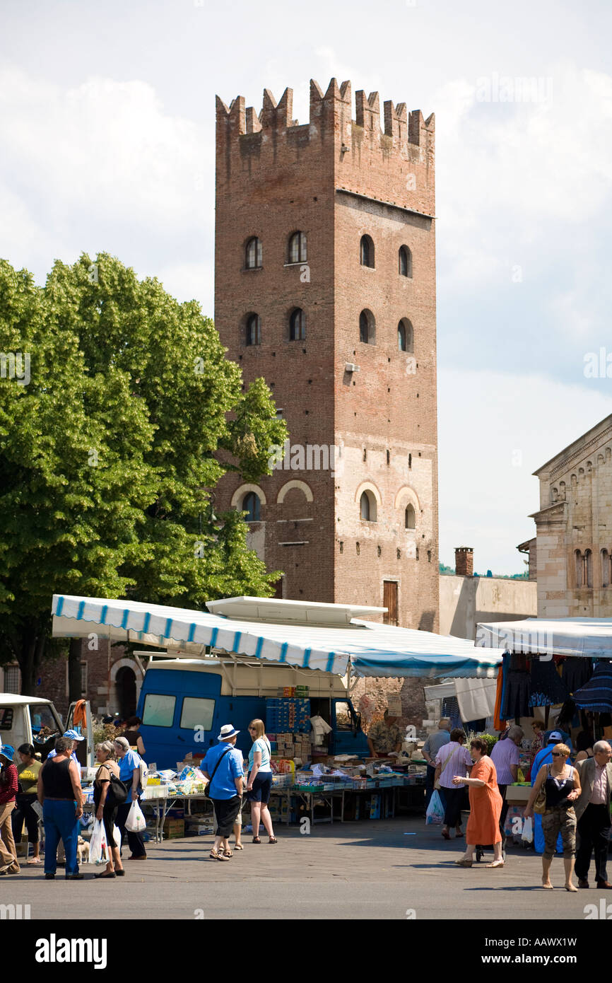 The C9th tower of the Romanesque basilica San Zeno Maggiore Verona Italy with the market in the Piazza San Zeno Stock Photo