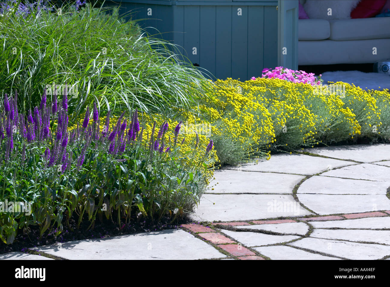 Curved path with flags and mixed planting Stock Photo