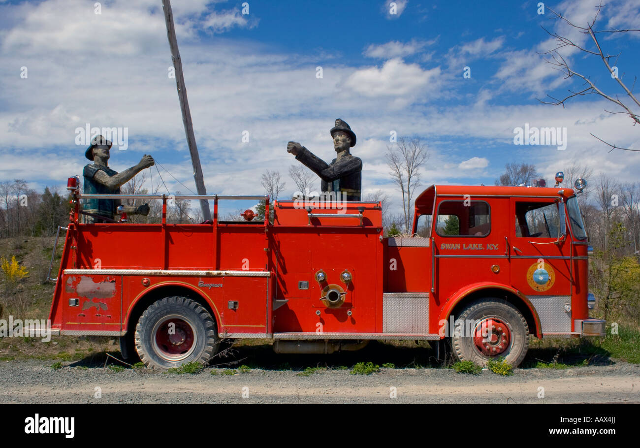 Wood carved firemen and old fire truck at the POW Memorial and September 11 Tribute in White Lake New York Stock Photo