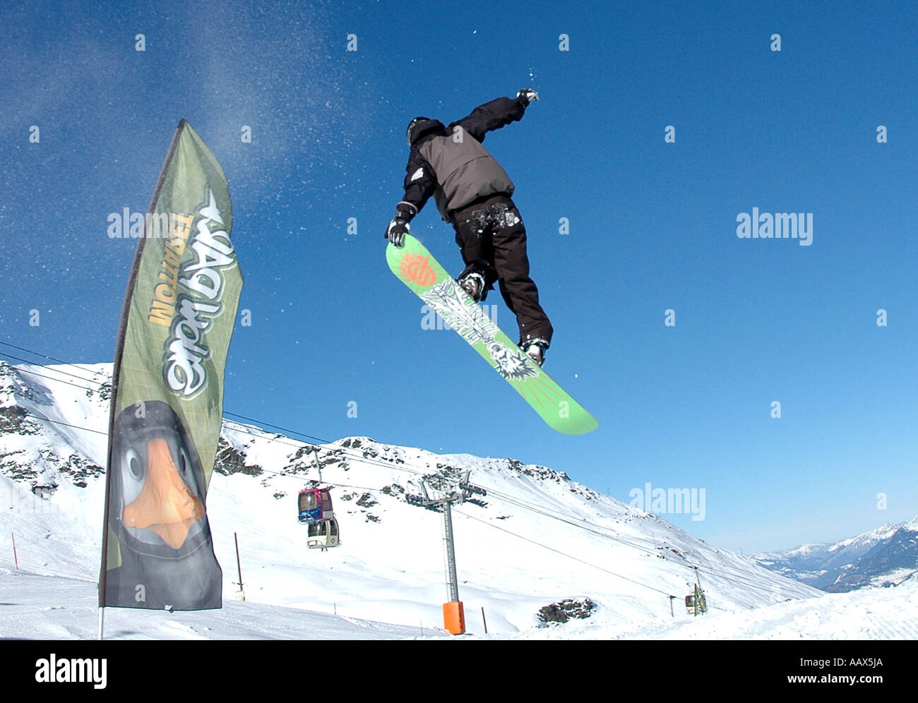 Young man jumping with snowboard Stock Photo