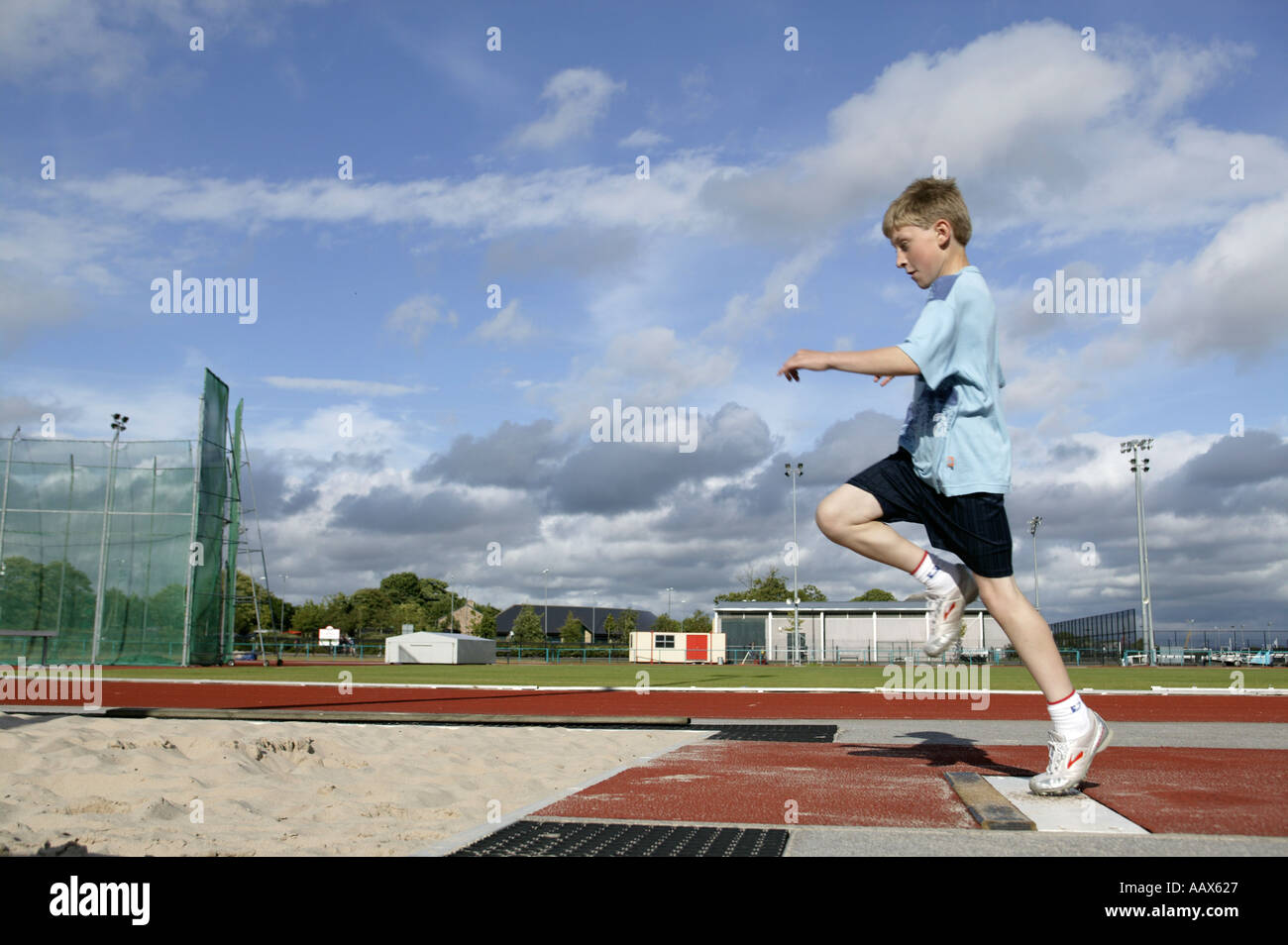 Young athlete competing in long jump Stock Photo