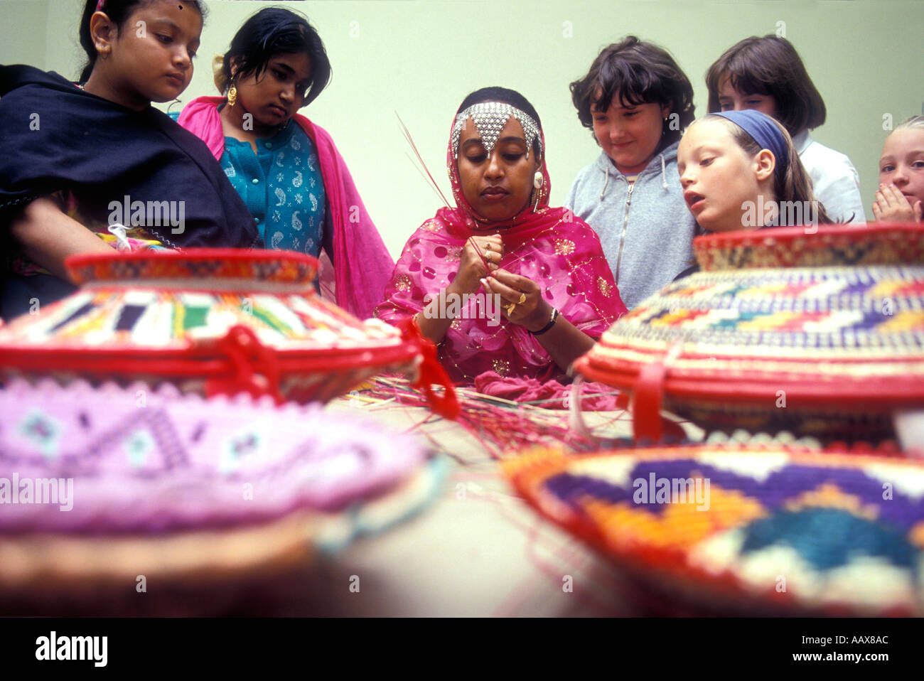 A demonstration of traditional basket weaving by an Asian woman in a primary school in London. Stock Photo