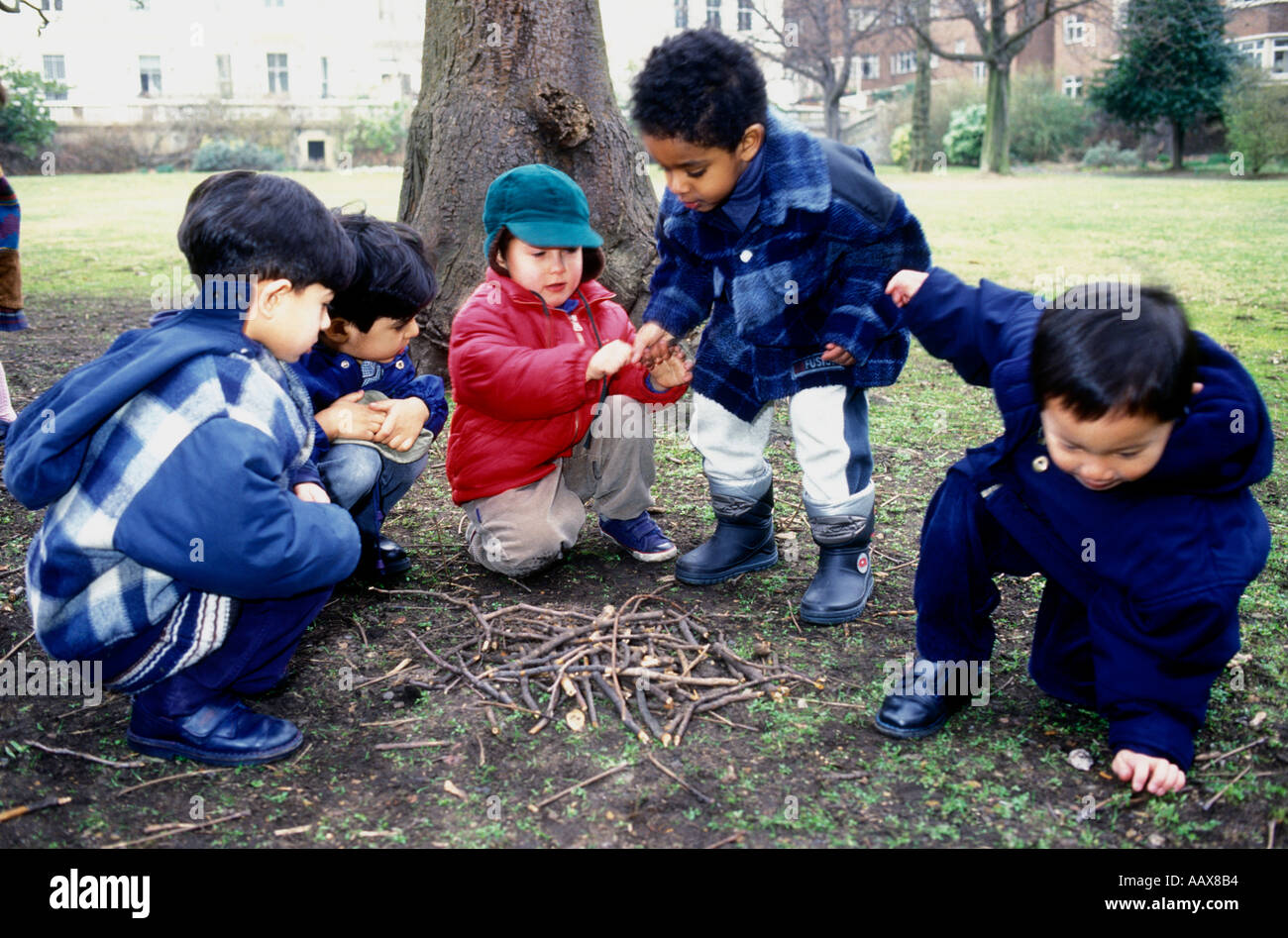 Young children learning about nature playing outside Stock Photo - Alamy