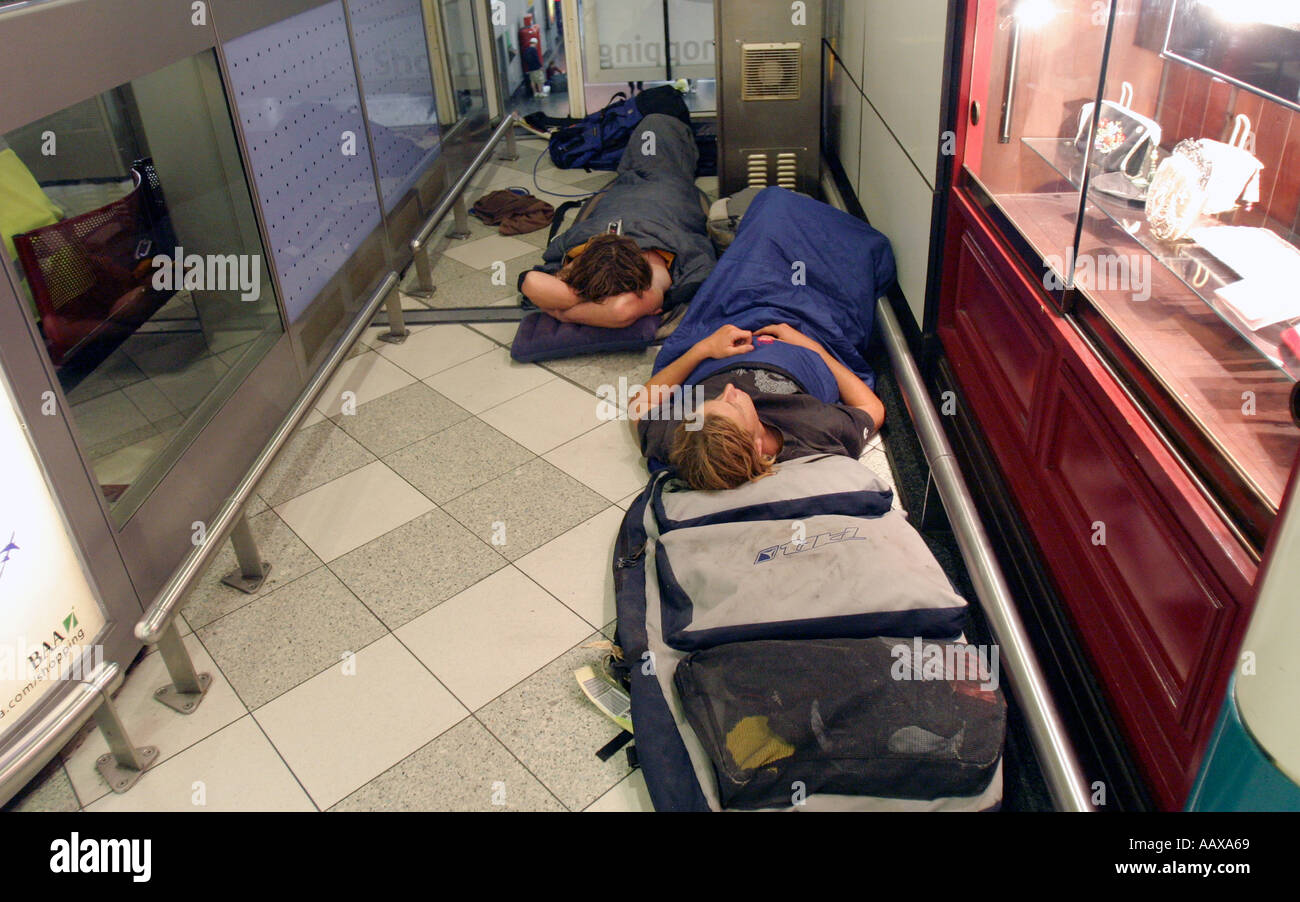 Passengers asleep on the floor at Gatwick airport due to delayed holiday flights. Stock Photo