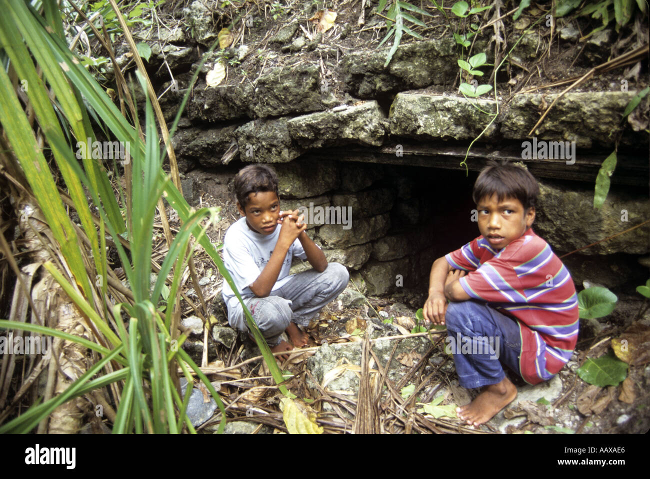 kids and WWII site in the remote islands of the Western Pacific Stock Photo
