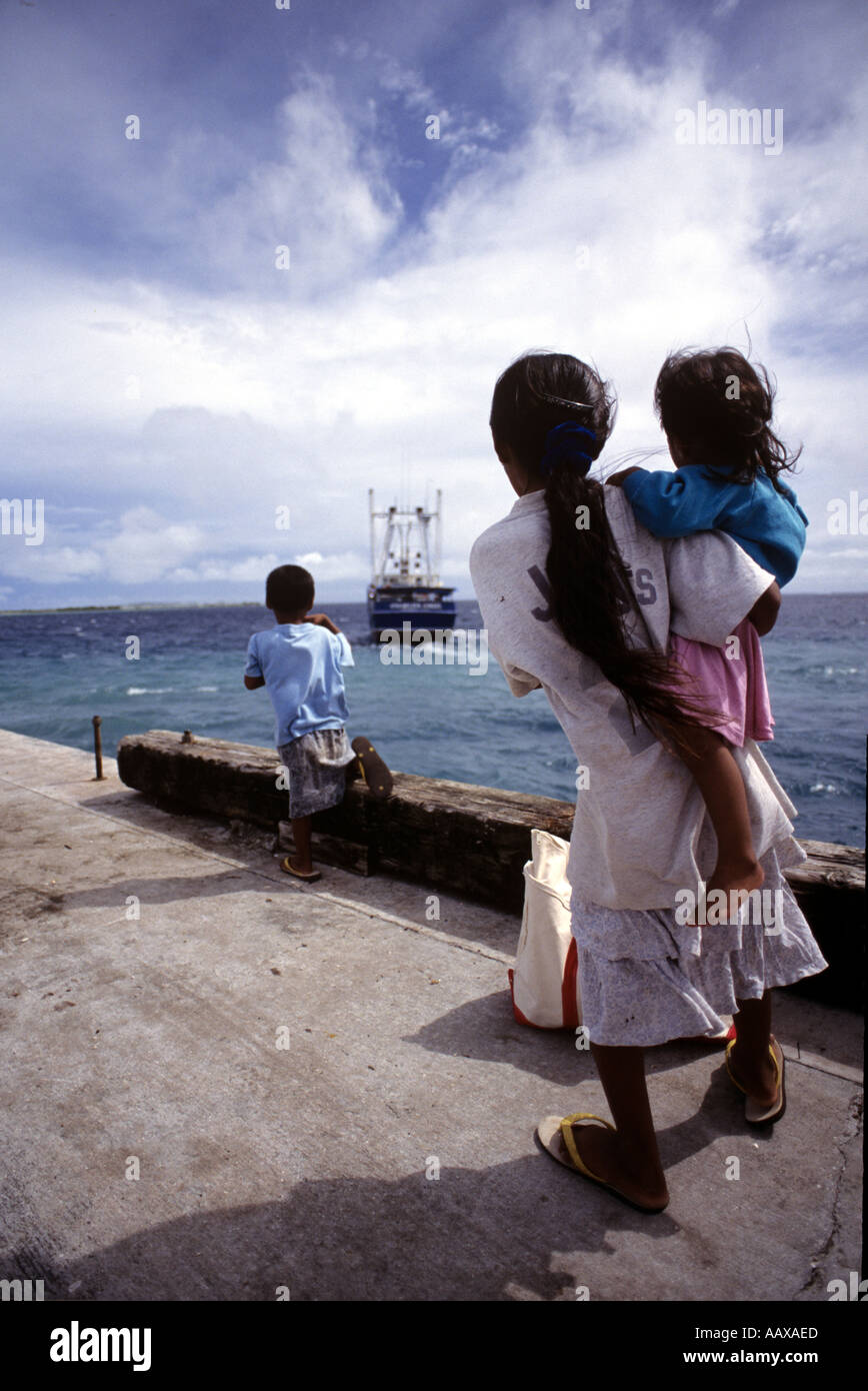 kids seeing off the local supply boat on the outer islands of the Marshall Islands Stock Photo