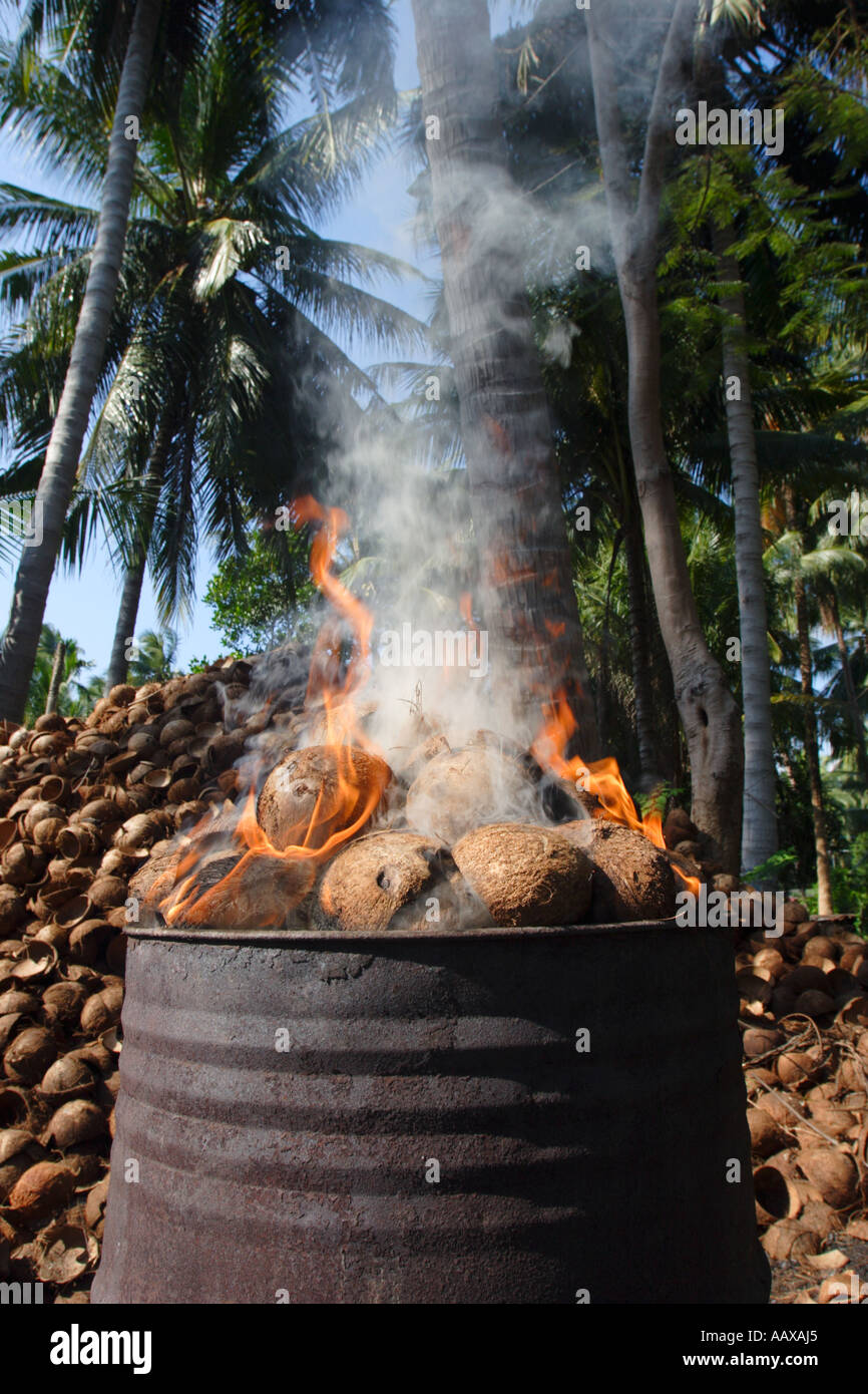Burning coconut husks to make charcoal, Koh Samui Thailand Stock Photo