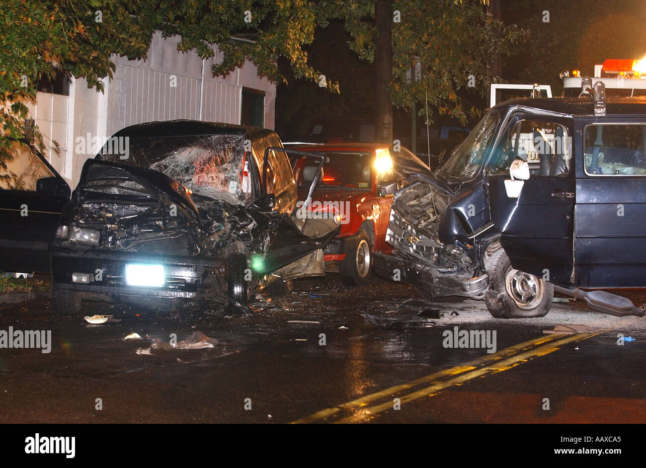 Three cars autos crashed in a head on collision Stock Photo