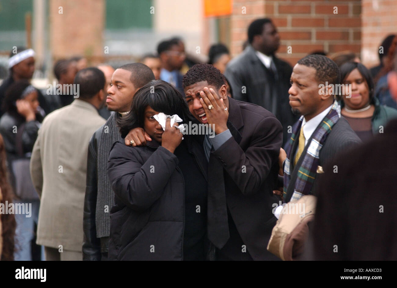 People leave a funeral crying after a gun violence murder in the United States Stock Photo