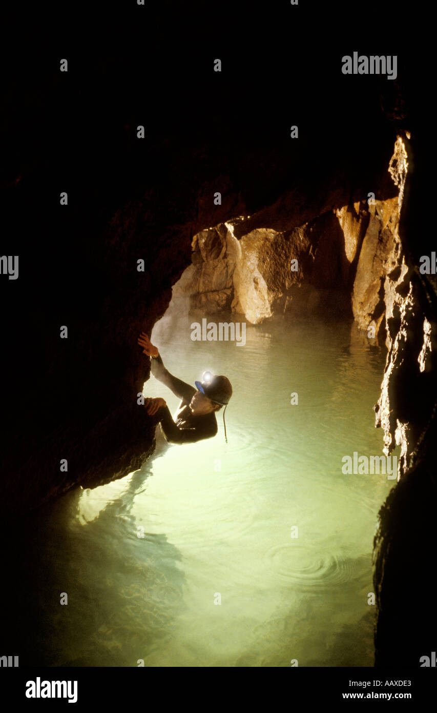 Caver in deep water in a South Wales cave UK Stock Photo