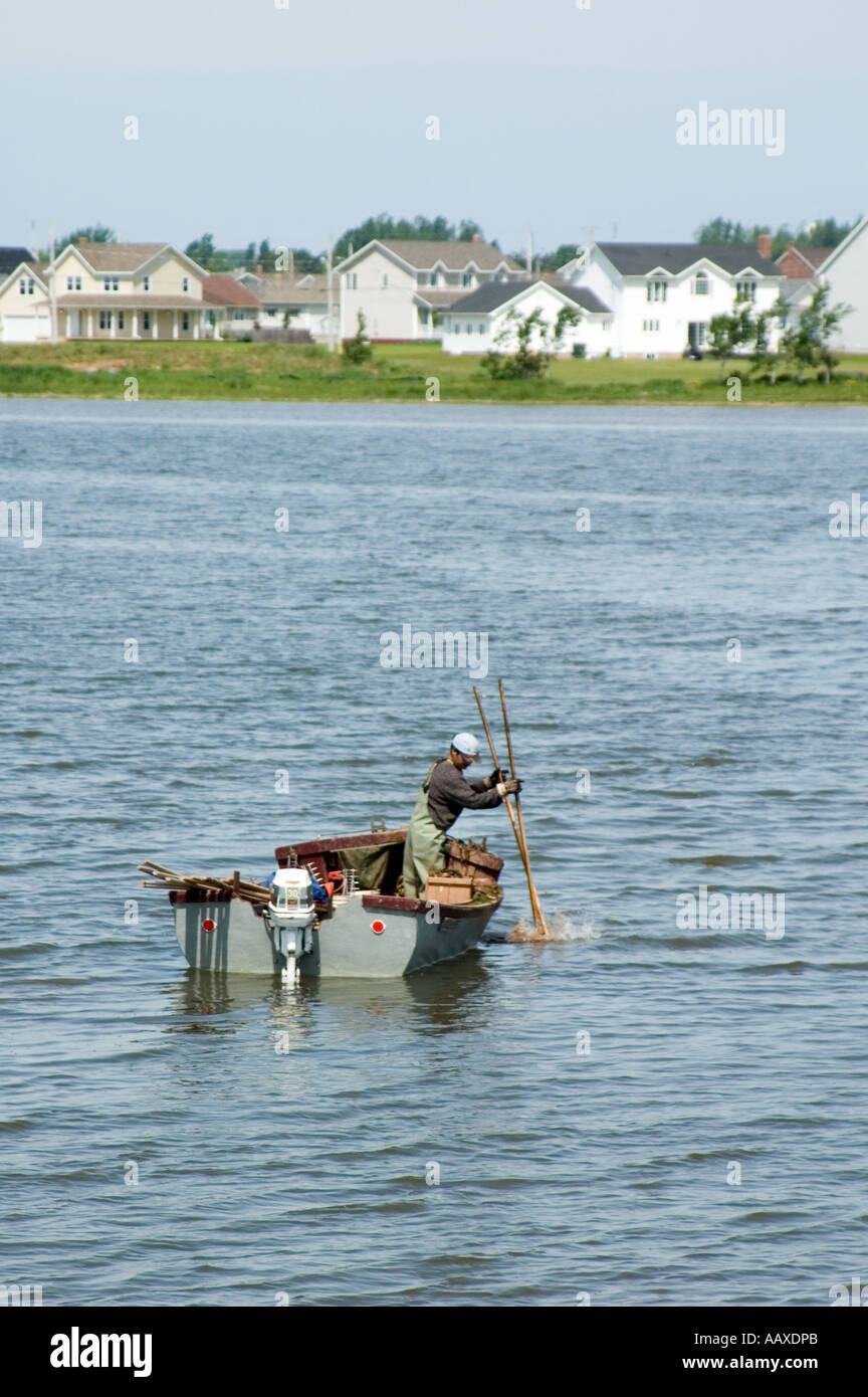 Man on a boat fishing in the atlantic ocean; prince edward island