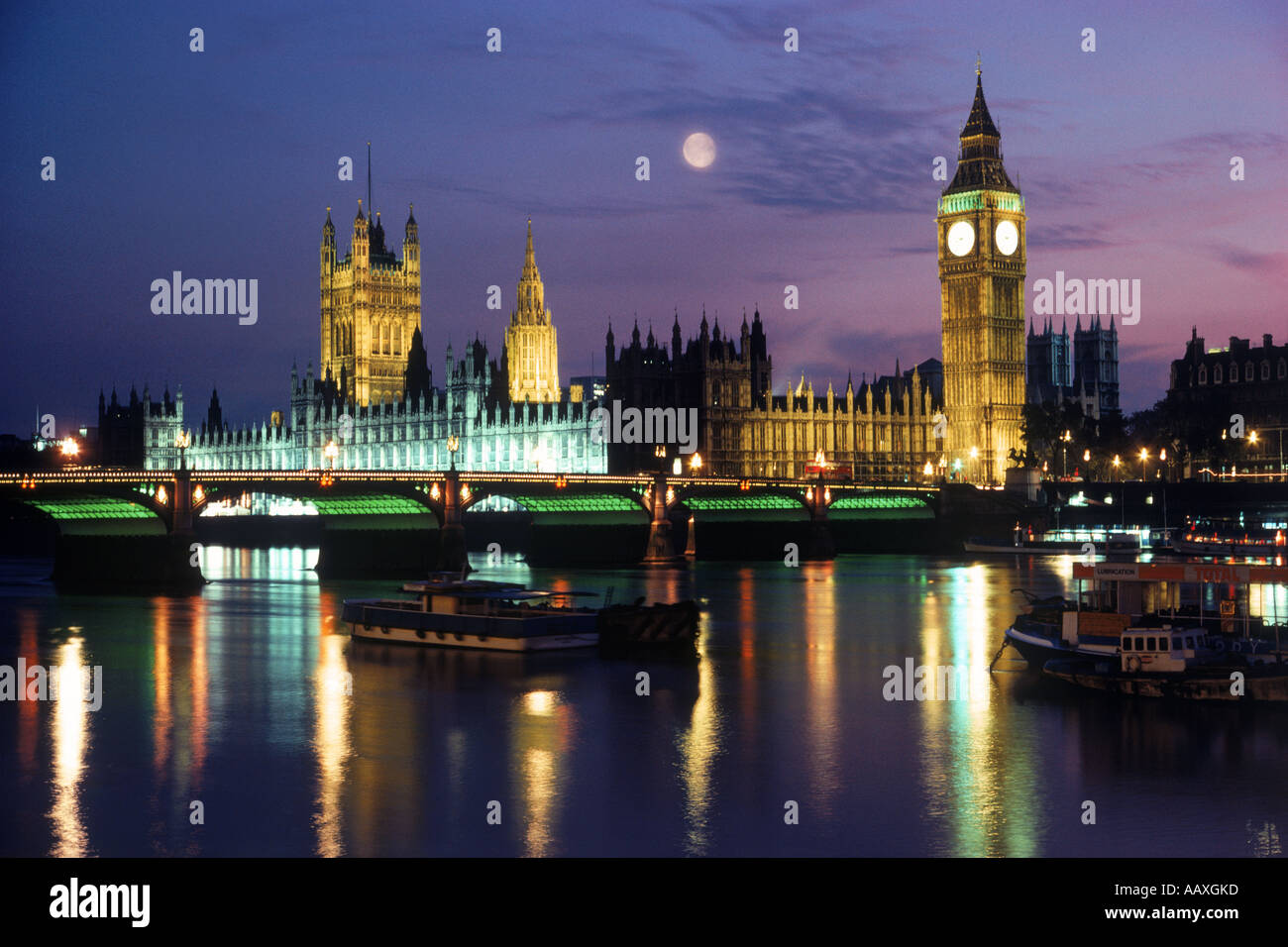 Big Ben and Westminster Bridge and full moon over River Thames at night Stock Photo