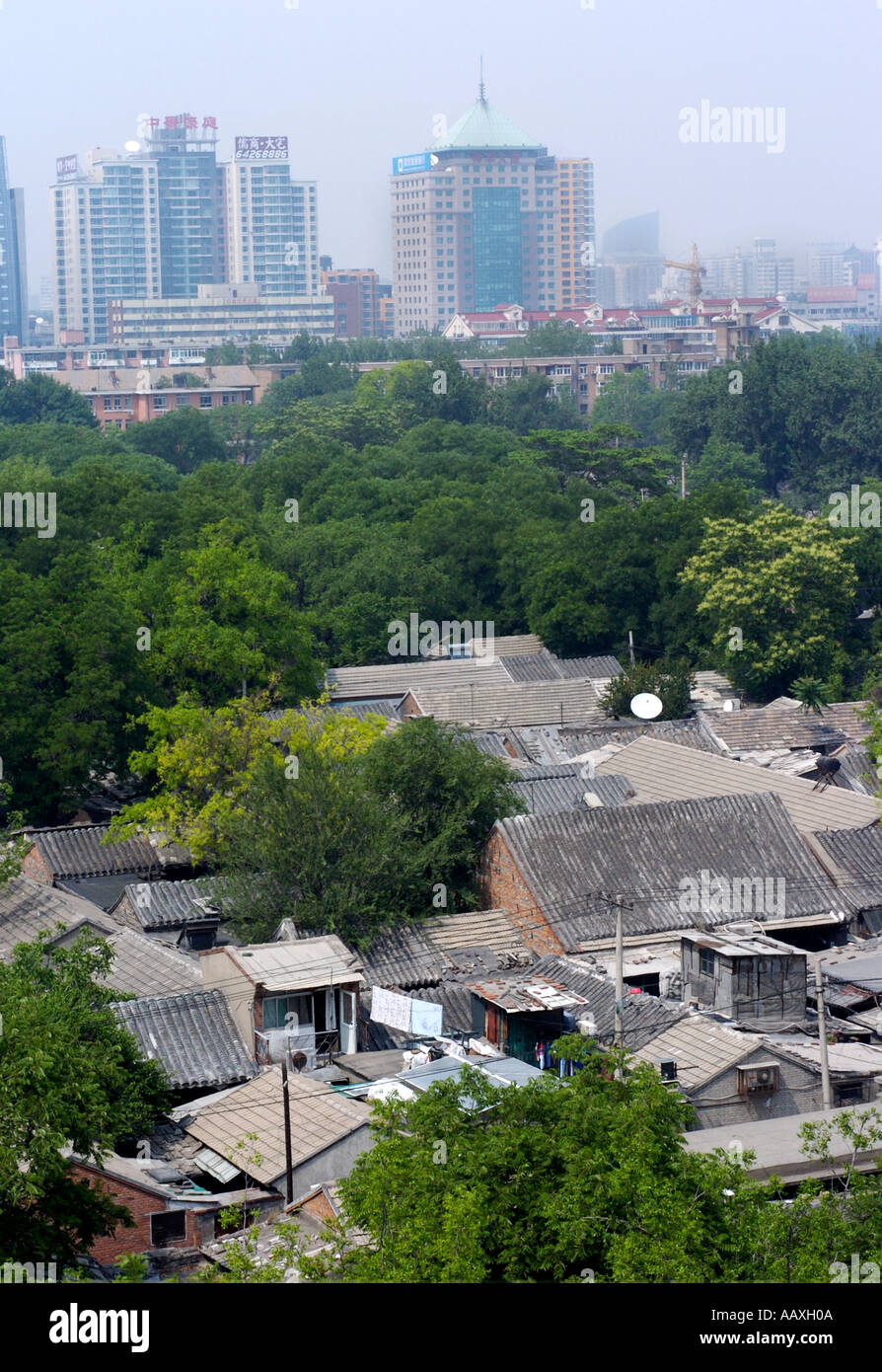 Rooftops of old houses in Beijing hutongs with new office developments in the distance 2005 China Stock Photo