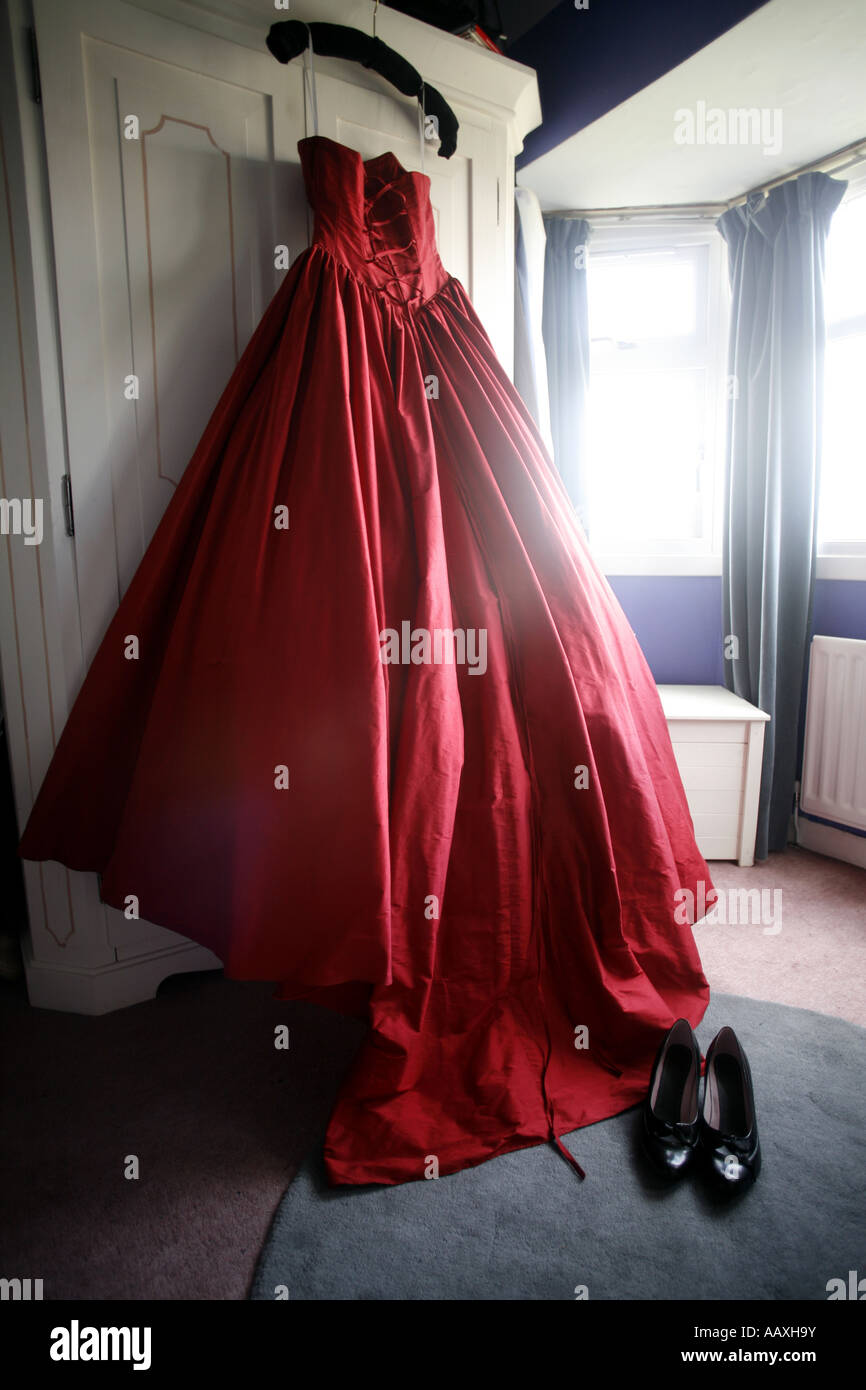 Red wedding dress hanging on a wardrobe Stock Photo - Alamy