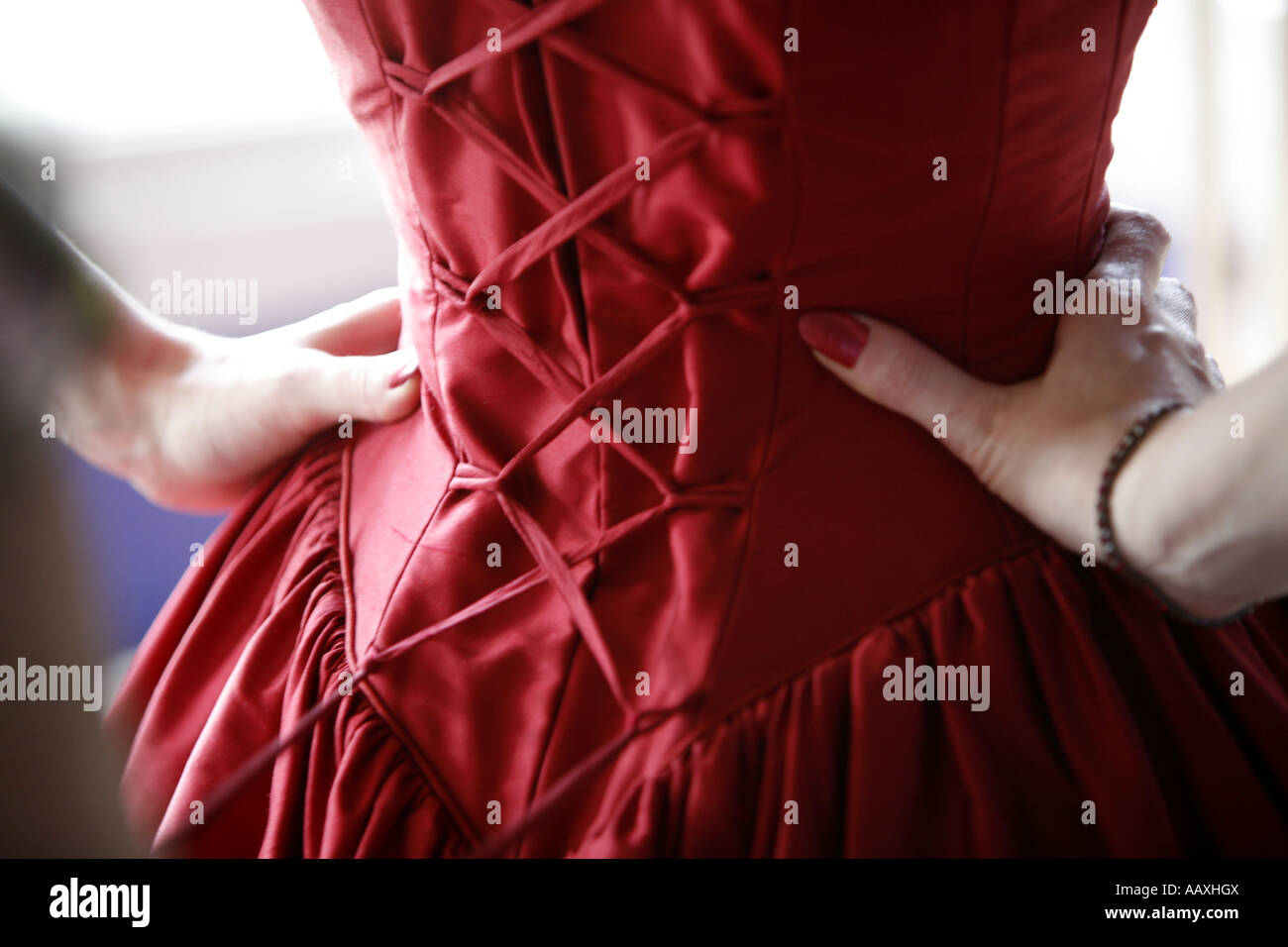 Girl wearing red wedding dress with hands on waist Stock Photo Alamy