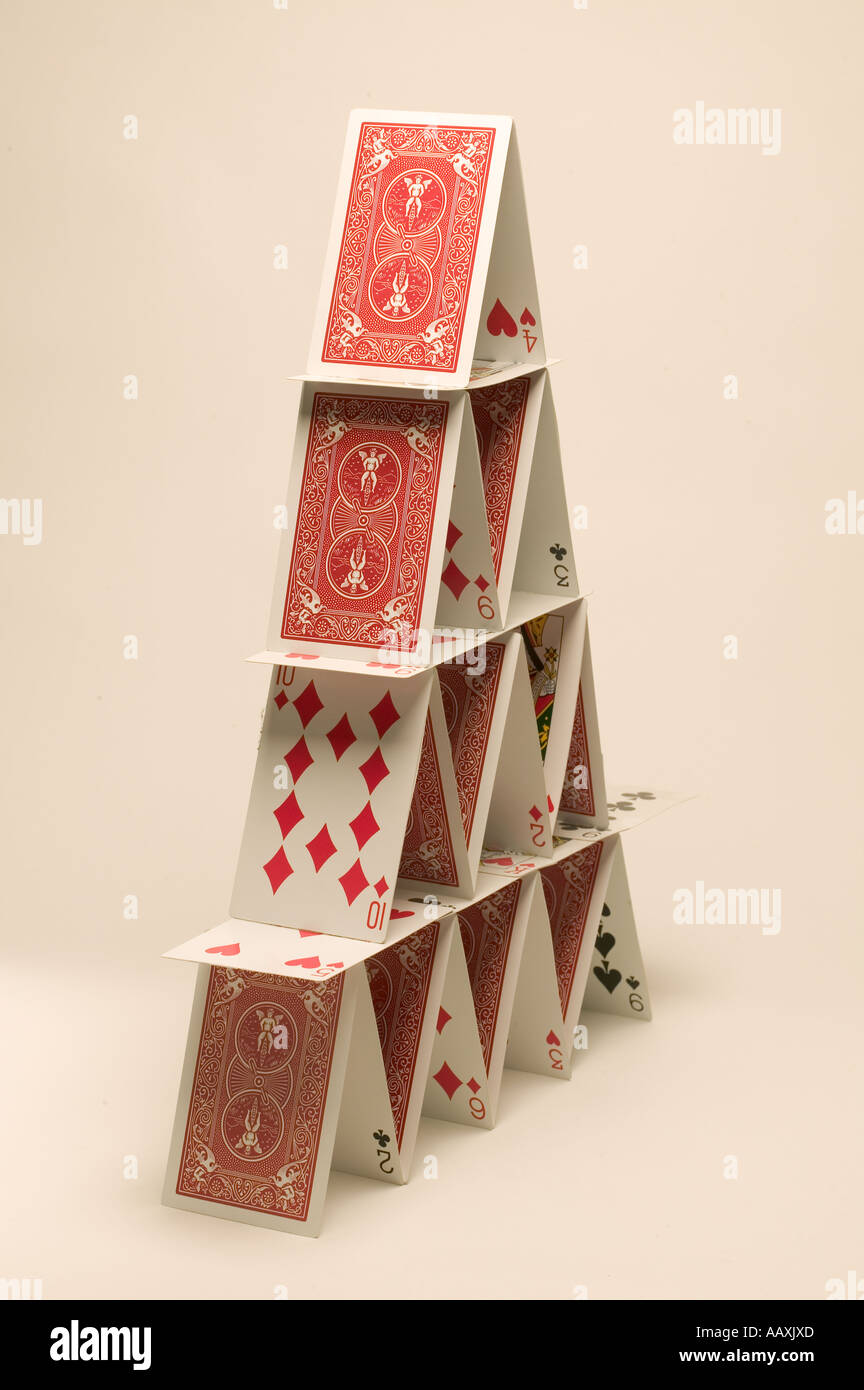 structure built by hand of a balanced card house Stock Photo