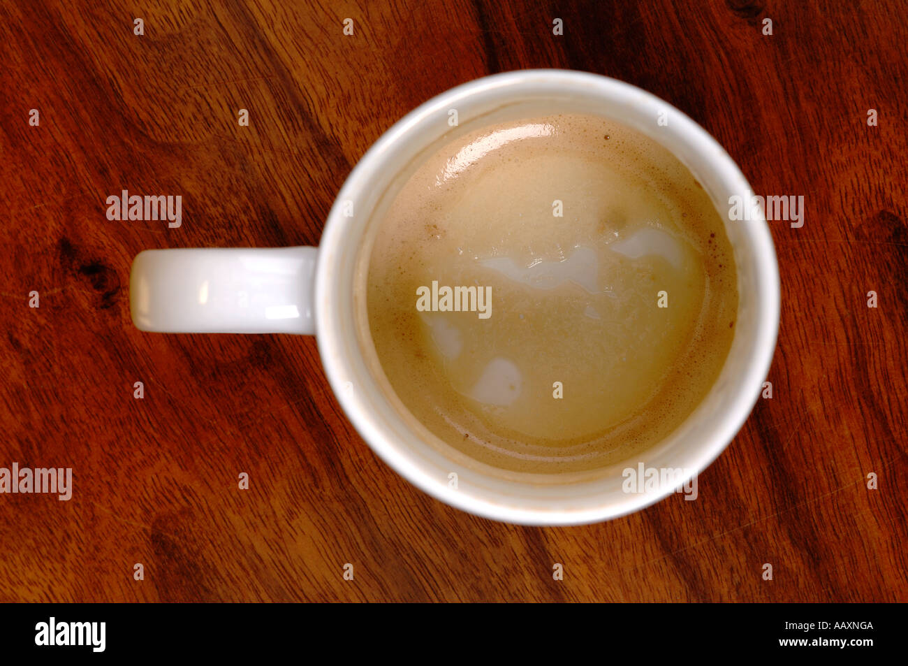 Overhead empty coffee mug on a wooden cafe table Stock Photo