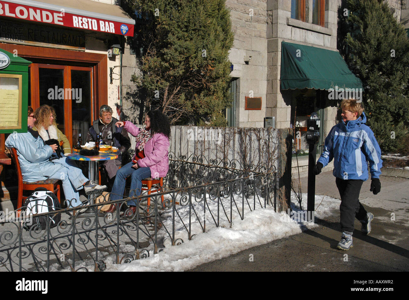 People on a terrace during the month of march on St Denis street Montreal Quebec Canada Stock Photo