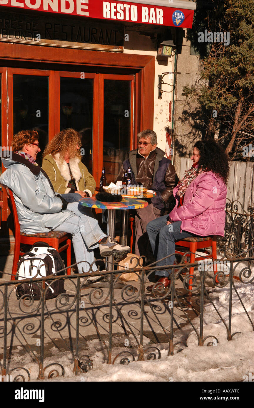 People on a terrace St Denis street in the month of march enjoying a beer Montreal Canada Stock Photo