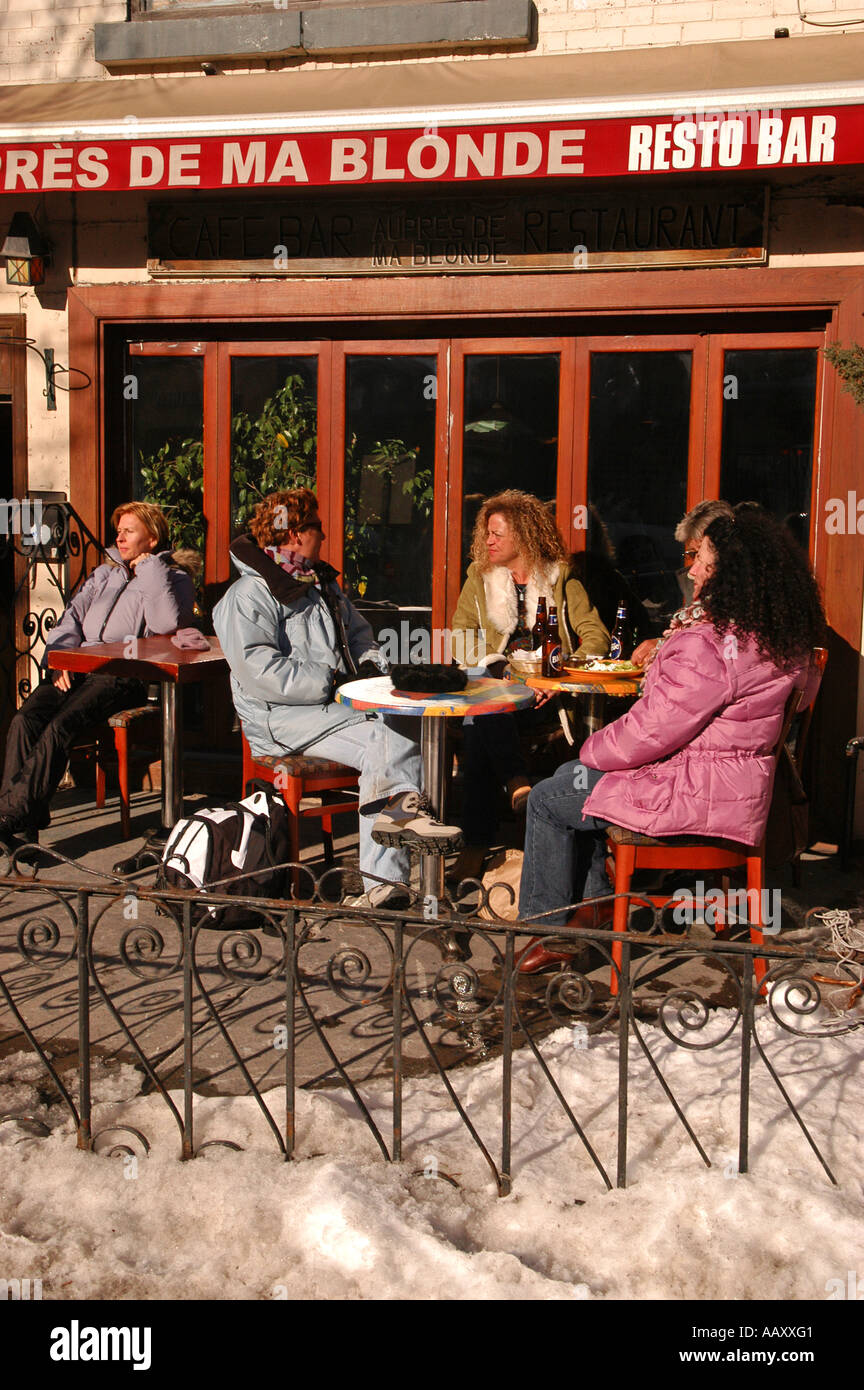 People having a drink during winter time ( month of March )on a terrace on St Denis street in Montreal Quebec Canada Stock Photo