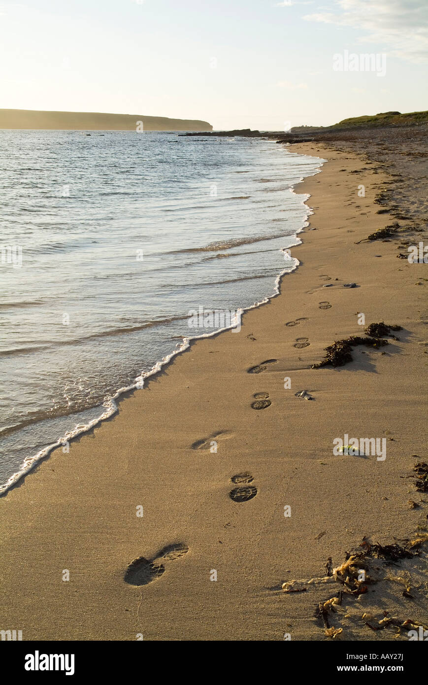 dh Birsay Bay BIRSAY ORKNEY Footprints in the beach sand along sunset seashore dusk empty foot prints Stock Photo