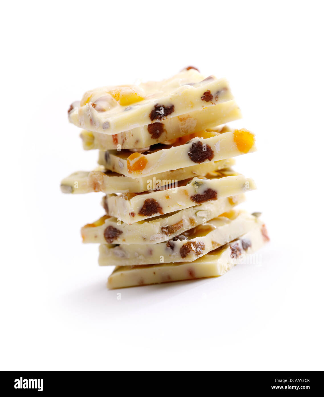 A stack of hand made white chocolate squares on a white background Stock Photo