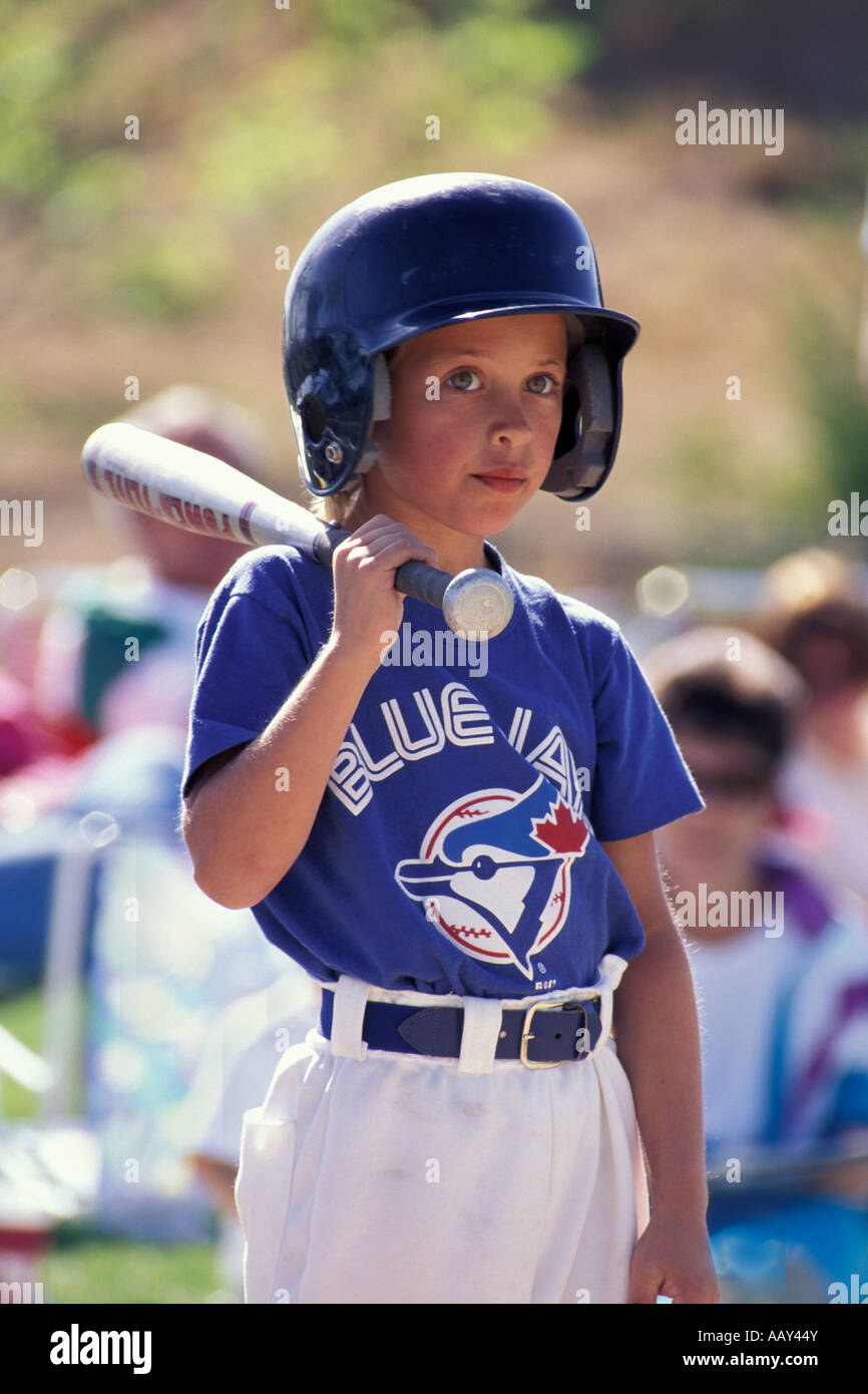 little league boy baseball player thinking about his turn at bat to hit a home run batter up sports vertical Stock Photo