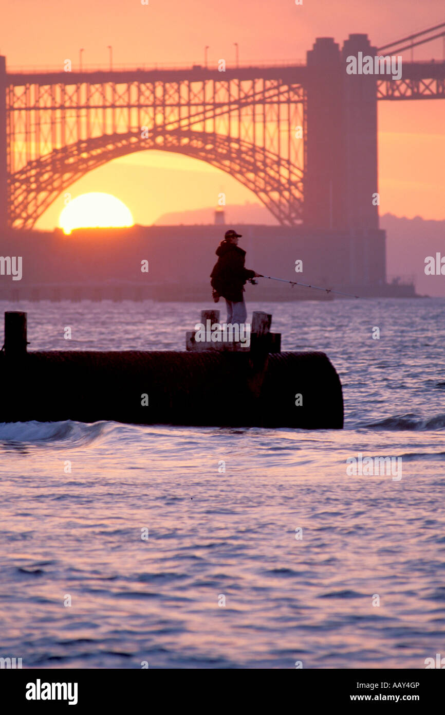 fisherman fishing with fishing pole on a dock in the San Francisco Bay area in California Stock Photo