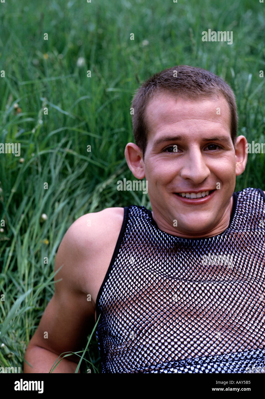 portrait of young man lying in the grass Stock Photo - Alamy