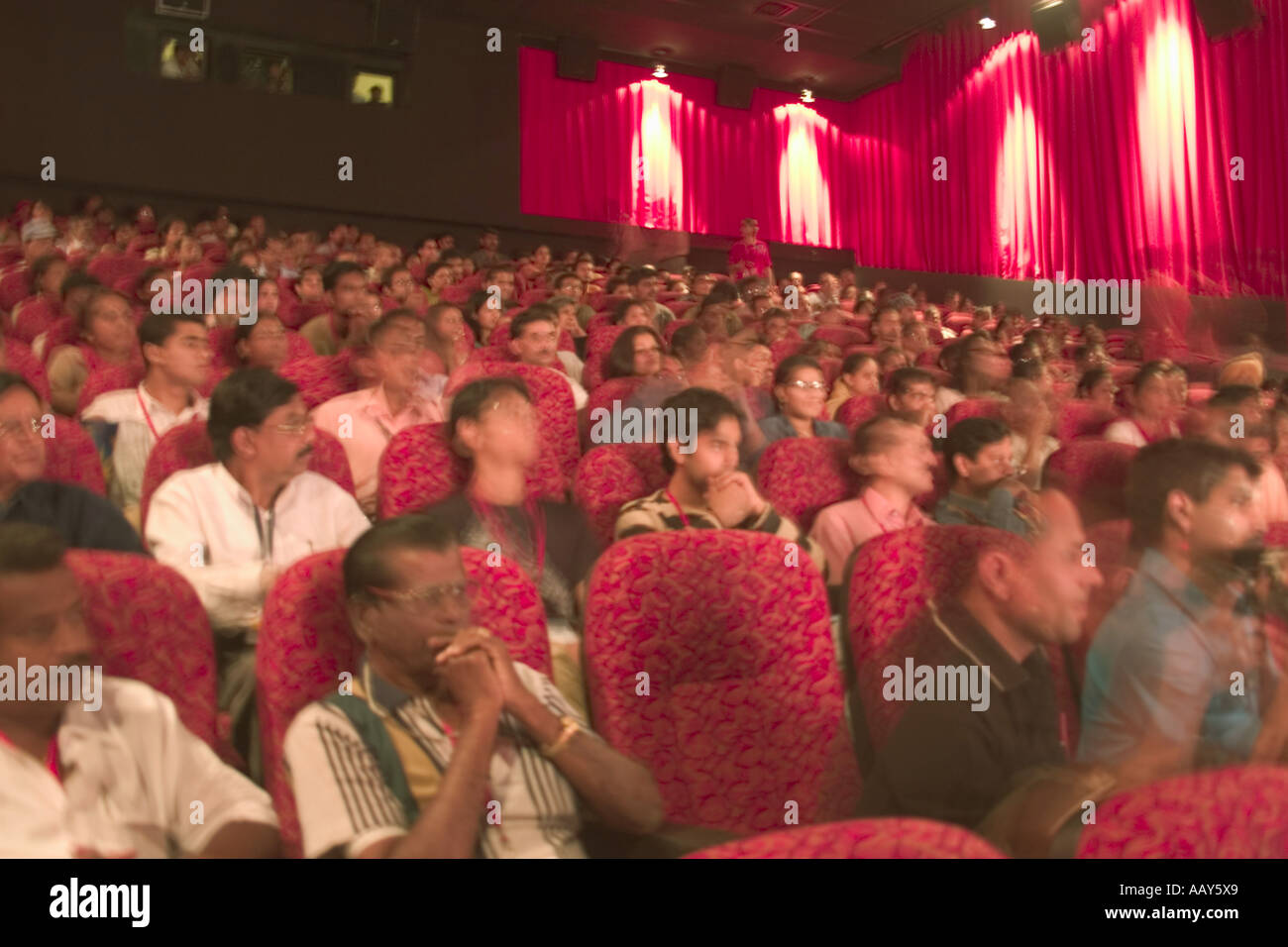 Movie hall red interior audience waiting for the screening of the film Goa India Stock Photo