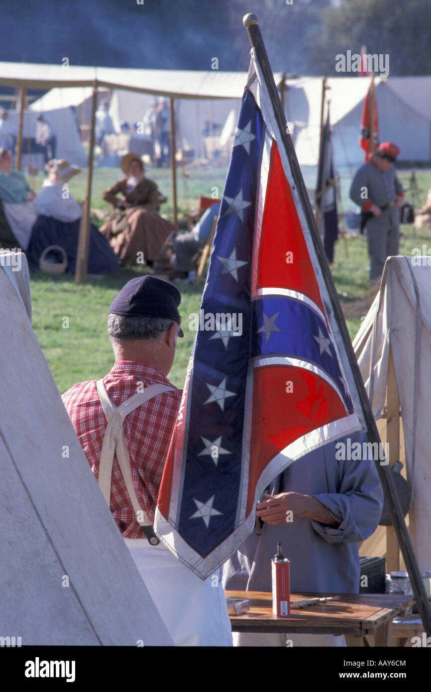 United States confederate flag at historic civil war reenactment with tents and soldiers vertical Stock Photo
