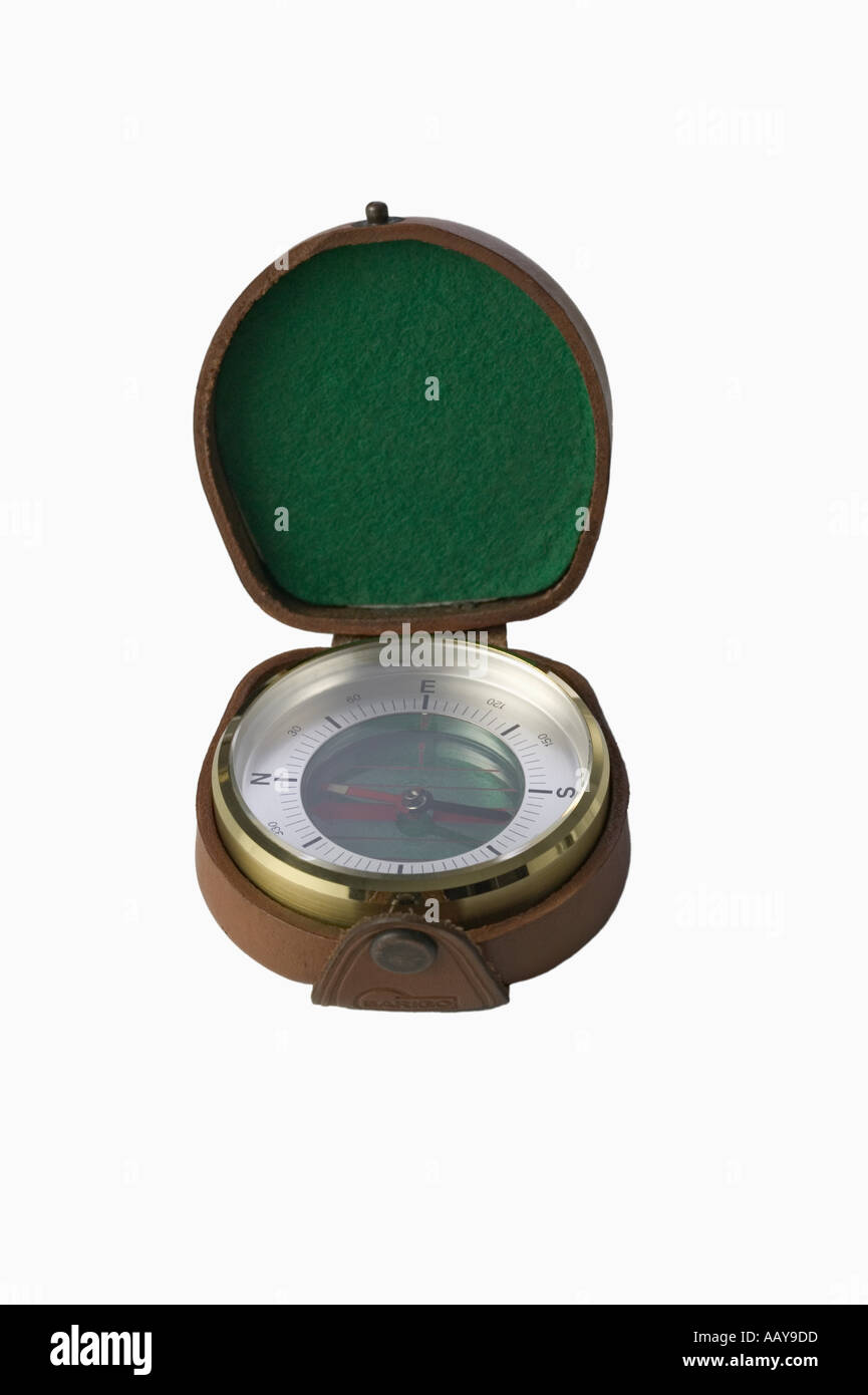 Still life of a compass in leather case silhouetted on white background Stock Photo
