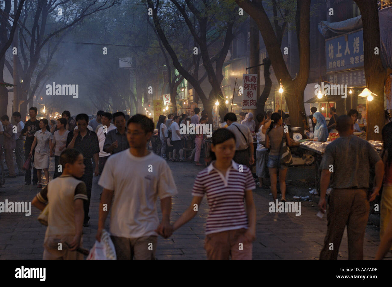 Xian, Shaanxi, China - The Muslim District Of Daqingzhen Si - People out in a busy street at night Stock Photo