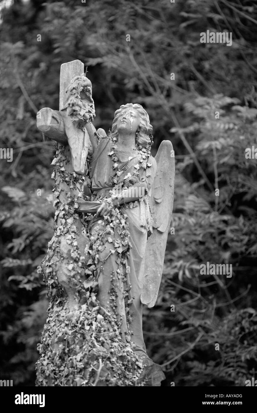 angel statue on top of a grave decay death Stock Photo