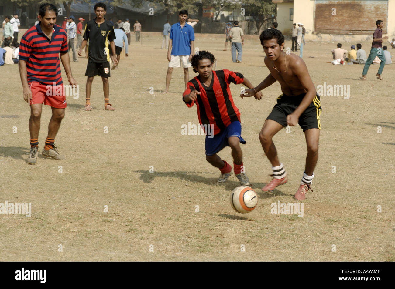 HMA78746 Indian boys playing football on playground Bombay Mumbai ...