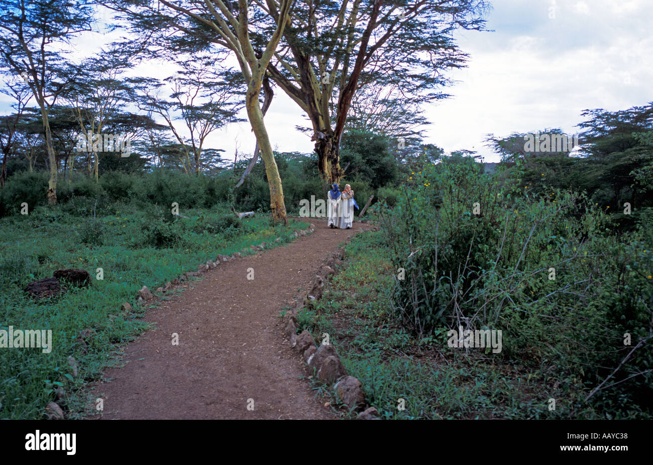 KENYA Nairobi National Park Muslim women walk on path in Nairobi National Park Kenya Africa Stock Photo