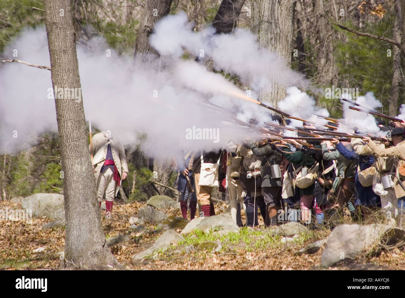 colonists fire weapons during battle reenactment Stock Photo