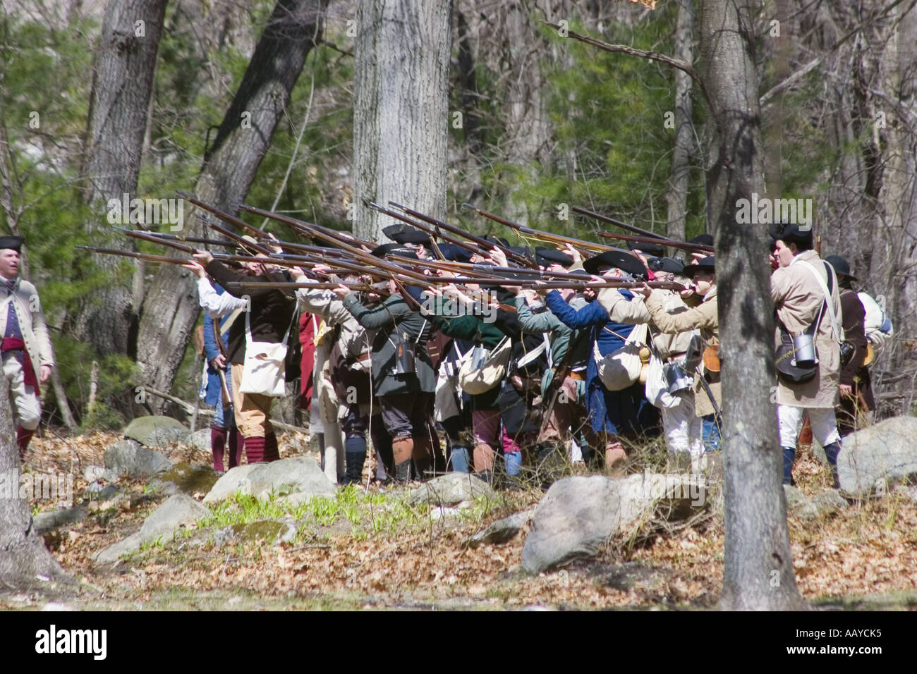 colonists prepare to fire weapons during battle reenactment Stock Photo