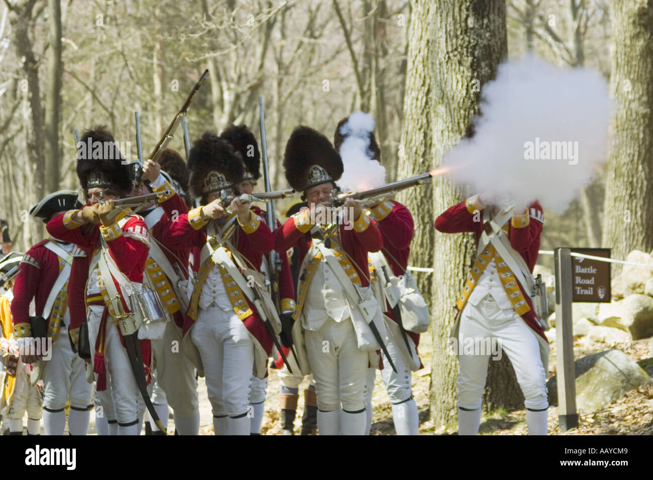 red coats fire rifles during battle reenactment Minute Man National Historical Park Massachusetts Stock Photo