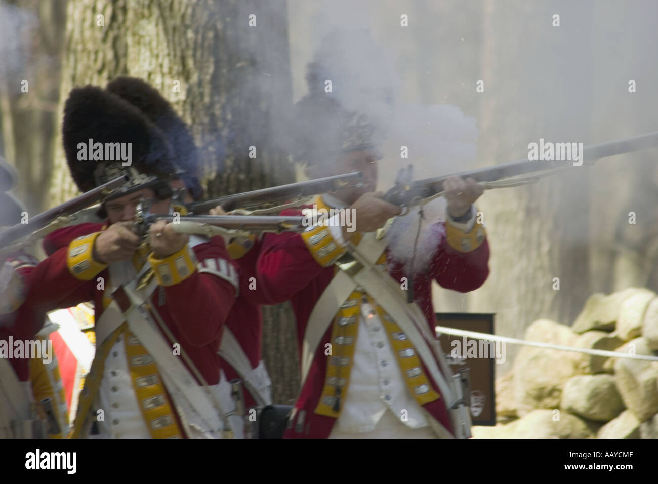 British soldiers fire rifles during battle reenactment Minute Man National Historical Park Massachusetts USA Stock Photo