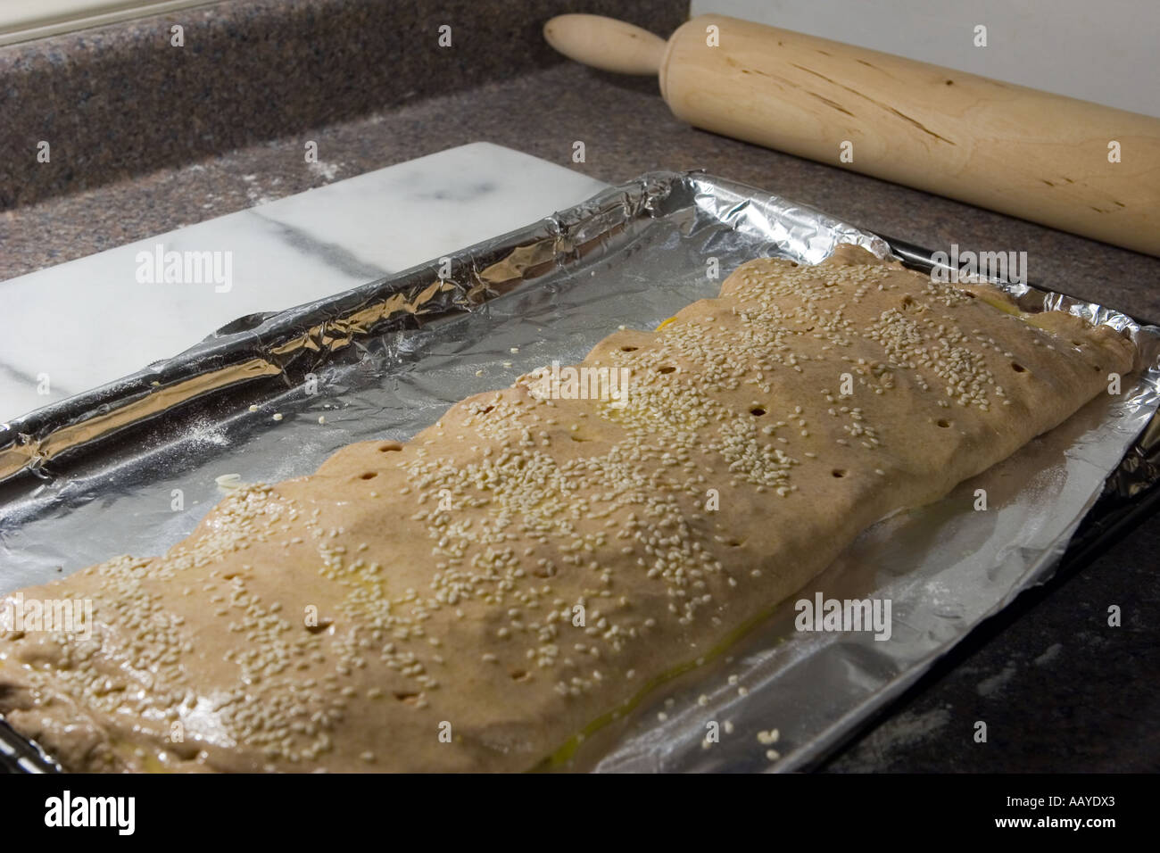 baking sheet with uncooked calzone on kitchen countertop Stock Photo