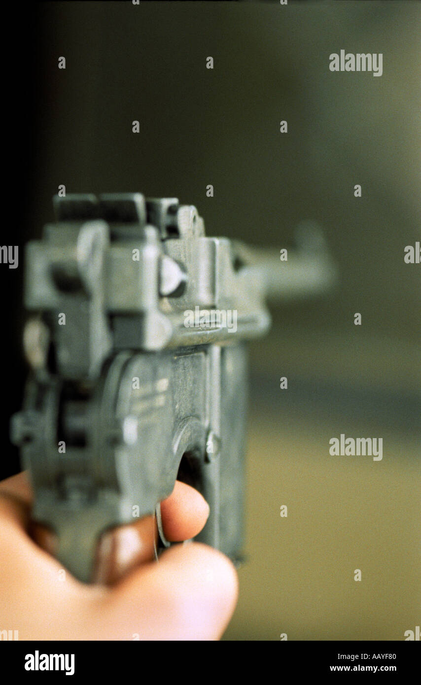blurred close up of hand holding a Mauser C96 pistol Stock Photo